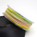 Detail shot of 1.2mm multicolored cotton cord with metallic gold thread on a spool - 1.2mm / 05# Yellow Green Pink