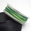 Macro detail of 1.2mm green segment dyed cotton cord with subtle gold glitter. - 1.2mm / 13# Dark Green Light Green