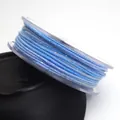 Detailed view of 1.2mm blue variegated braided cotton cord with glitter on clear spool - 1.2mm / 20# Dark Light Blue Segment Dyed