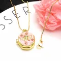 Macro view of gold-plated octagonal angel locket necklace with pink enamel and zircons - Blue B + Necklace