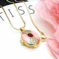 Detailed view of an ornate gold-plated locket necklace featuring pink enamel and zircons - Necklace Set / Pink And Red