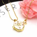 Close-up detail of gold angel heart locket necklace with white enamel and zircons - Purple B+ Necklace