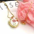 Close-up of gold-plated oval locket necklace with colorful enamel flower pendant - Necklace Set / White
