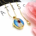 Detailed close-up of gold-plated copper locket with blue enamel and red zircon stone - Necklace Set / Blue and Red