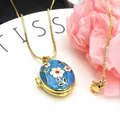 Detailed macro shot of an elegant gold-plated flower locket necklace with blue enamel - Necklace Set / Blue
