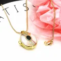 Close-up of gold-plated oval locket necklace with green gemstone and enamel detail - Necklace Set / White and Green