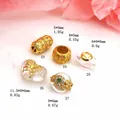 Detailed view of various gold-plated zirconia beads and charms for DIY jewelry making projects. - Rhinestone Inlaid Barrel Bead (23#) / 23