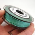 Close-up detail of 0.85mm shimmering teal jade thread on spool for DIY jewelry making - Approximately 0.8mm / Light Green
