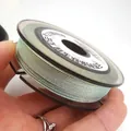 Close-up view of 0.85mm iridescent braided jade thread on a spool for DIY jewelry - Approximately 0.8mm / Mint Green