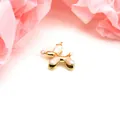 Macro detail view of a gold-plated balloon dog charm featuring pearly white enamel finish - White