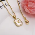 Detail view of gold letter K pendant with shell inlay and zirconia embellishments. - Letter K