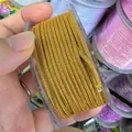 Macro detail of 2.0mm gold metallic braided cord on spool for DIY jewelry crafts - 2mm / Gold 2