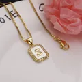 Close-up of a gold-plated square pendant with letter S, sparkling zirconia, and shell inlay. - Letter S