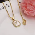 Gold rectangular pendant necklace with white shell inlay and zirconia letter T - Letter T