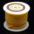 Detailed macro shot of golden yellow 3mm braided cord on a spool for DIY jewelry crafts - Gold Yellow