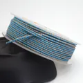Detail of 1.5mm blue and gold dragon pattern braided cord wound on a white plastic spool - Blue and Golden Brown Dragon Cord (64#) / 1.5mm 10m/Roll