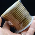 Close-up of a bronze 3mm braided polyester cord roll for DIY jewelry making and necklaces - Approximately 3mm / Yellow Brown