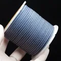 Blue-grey 2mm braided nylon cord on a white spool for DIY jewelry and handcrafts - Lake Blue