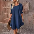 Detail view of a vintage navy blue cotton linen dress with ruffle sleeves and hem - Dark Blue