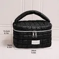 Large black quilted puffer cosmetic bag with handle and zipper, measuring 24x16x15.5cm - Barrel Bag / Black