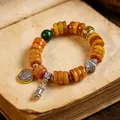 Ethnic style Tibetan bracelet with amber-colored beads, Zhakilamu charm and mantra wheel - Zaki Lhamo Six-Syllable Mantra Style / High-end Spacer Style / Yellow