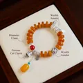 Vintage ethnic style bracelet featuring 12mm orange beads and lucky cat silver charms. - Wealth Rolling In Fortune Cat Style (Large) / 12mm Bead Diameter / Orange-Yellow