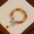 Vintage ethnic style bracelet with orange beads and lucky antique silver charms - Koi and Auspicious Elephant (Instant Wealth)