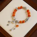 Retro ethnic style bracelet with orange agate beads and silver charms - Wisdom Eye Fortune Bag (Tibetan Style)