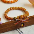 Retro ethnic style yellowish beaded bracelet featuring a Zaki Lhamo deity pendant - Leather Pendant Manjushri Style / Amber