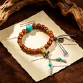 Handcrafted ethnic style ox bone bead bracelet with turquoise and Tashi Lhamo pendant - Cow Bone: Engraved Turquoise Yellow Wealth God Bracelet