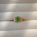 Close-up of a green real dried flower encapsulated in a gold-plated stainless steel ring - Gold Base Green Dried Flower Style(4) / Green