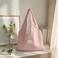 Casual pink star pattern tote bag displayed in a cozy lifestyle indoor setting. - Pink with Small Stars