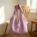 Lavender purple vest-style tote bag with star patterns hanging on a wooden chair. - Purple with Small Stars