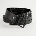 Close-up detail of black leather punk belt featuring three rows of pyramid studs - Black