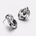 Close-up of minimalist silver metallic intertwined hoop stud earrings for women - Medium Style (White K-Gold) / Silver