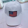 Classic white cotton baseball cap featuring a detailed embroidered US flag patch on the front - One Size / US Flag White