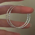 Elegant S925 sterling silver hoop earrings with a sparkling diamond-cut texture finish. - Large-EHR124 / 40mm