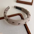 Cerchietto imbottito elegante in tessuto grigio-marrone con motivi a fiocco neri per donne - Stile Caffè Chiaro Fiocco (27305D)