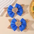 Two blue ribbon bow hair clips with glitter heart centers and sparkly butterfly accents. - Sequin Heart Bow (2A-6)