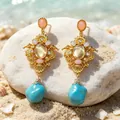Vintage gold drop earrings with turquoise and pink gemstones on a sunny beach - Palace Style Blue Teardrop Rhinestone Earrings (2608103) / Blue/Gold