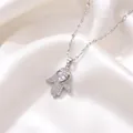 Detailed close-up of a silver Hamsa hand necklace pendant featuring a sparkling heart-shaped zircon. - Hamsa Hand Heart Style (X1597)