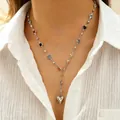 Stainless steel necklace with colorful zircon beads and silver heart pendant on model. - Y-shaped Colorful Zirconia Heart Necklace (1969)