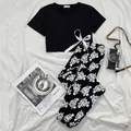 Two-piece women's pajama set featuring a black crop top and floral print long pants - S / Top And Bottom / Black and White Rose Print