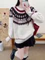 Detail view of an oversized Fair Isle knit sweater with red and white festive Christmas patterns - One Size / Tops / Off White