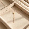 Elegant 18k gold plated titanium steel necklace with bead pendant displayed in a velvet jewelry box - Triple Round Bead Streamline Clavicle Chain (LLN847GL) / Gold