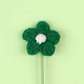 Macro detail of a handmade green crochet knitted flower with a white center on a stem - Christmas Puff Flower (Green Petal White Stamen) / Green and White