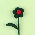 Macro view of handmade dark green crochet flower with red center and green leaf - Christmas Puff Flower Stem / Green Puff Dark Green Leaf