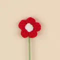 Macro view of a handmade red and white crochet flower accessory with a green stem - Christmas Puff Flower (Red Petal White Stamen) / Red And White