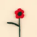 Close-up detail of a handmade red and green crochet wool flower branch with soft yarn texture - Christmas Puff Flower Stem / Red Flower Dark Green Leaf