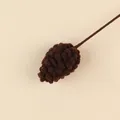 Detailed view of a handmade brown crochet pinecone decoration for DIY Christmas floral bouquets - Pine Cone Stem / Dark Brown